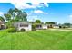 Beautiful home with a sprawling green lawn, manicured bushes, and a quaint, quiet street at 3716 Neptune Dr, Orlando, FL 32804
