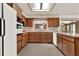 Efficient kitchen features wood cabinetry, white appliances, and plenty of counter space at 3716 Neptune Dr, Orlando, FL 32804