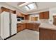 Bright kitchen with wood cabinets, white appliances and countertops, and a unique skylight at 3716 Neptune Dr, Orlando, FL 32804