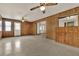 View of the spacious room featuring wood paneling, ceiling fans, and access to outdoor areas at 3716 Neptune Dr, Orlando, FL 32804