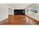Spacious living room with hardwood floors, a large built-in bookshelf and bright natural light at 3716 Neptune Dr, Orlando, FL 32804