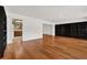 Hardwood floors and bright, natural light lead through the living room to the kitchen at 3716 Neptune Dr, Orlando, FL 32804