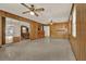 A spacious living room featuring wood paneling, ceiling fans, and outdoor access at 3716 Neptune Dr, Orlando, FL 32804