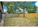 Spacious backyard with a wood fence offering privacy, with view of the screened lanai at 378 Cedarbrook Ln, Altamonte Springs, FL 32714