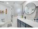 Modern bathroom with glass-enclosed shower, vanity with marble countertop, and round mirror at 378 Cedarbrook Ln, Altamonte Springs, FL 32714