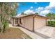 Beige one-story home featuring an attached two-car garage with walkway at 378 Cedarbrook Ln, Altamonte Springs, FL 32714