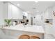 Bright, renovated kitchen with white cabinets, marble countertops, and breakfast bar at 378 Cedarbrook Ln, Altamonte Springs, FL 32714