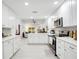 Bright kitchen with white cabinets, stainless steel appliances, and an eat-in bar at 378 Cedarbrook Ln, Altamonte Springs, FL 32714