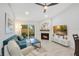 Bright living room with a fireplace, fan, light gray floors, and glass sliding doors at 378 Cedarbrook Ln, Altamonte Springs, FL 32714