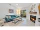 Bright living room with a fireplace, fan, light gray floors, and glass sliding doors at 378 Cedarbrook Ln, Altamonte Springs, FL 32714