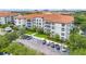 Condo building featuring a red tile roof, balconies, and lush landscaping at 4001 Breakview Dr # D409, Orlando, FL 32819