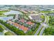 Panoramic aerial view of a community with various buildings, lush landscaping, water features, and nearby amenities at 4001 Breakview Dr # D409, Orlando, FL 32819