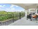 Relaxing balcony with chairs, offering serene views of lush greenery and blue skies at 4001 Breakview Dr # D409, Orlando, FL 32819