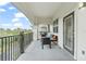 Relaxing balcony with chairs, offering serene views of lush greenery and blue skies at 4001 Breakview Dr # D409, Orlando, FL 32819