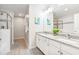 Bathroom with double sinks, granite countertops, and a glass-enclosed shower at 4001 Breakview Dr # D409, Orlando, FL 32819