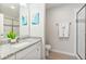 Bright and clean bathroom with a dual sink vanity and glass-enclosed shower at 4001 Breakview Dr # D409, Orlando, FL 32819