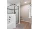 Bright bathroom featuring a shower with glass door and a separate bathtub at 4001 Breakview Dr # D409, Orlando, FL 32819