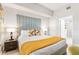 Comfortable bedroom featuring a padded headboard and modern lamps at 4001 Breakview Dr # D409, Orlando, FL 32819