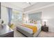 Bright bedroom featuring a plush bed with decorative pillows, a desk, and a ceiling fan at 4001 Breakview Dr # D409, Orlando, FL 32819