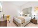 Comfortable bedroom with a stylish desk, queen bed, modern headboard, and natural light at 4001 Breakview Dr # D409, Orlando, FL 32819