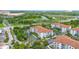 An aerial shot of multiple buildings with terracotta roofs, green landscaping, and easy access to roadways at 4001 Breakview Dr # D409, Orlando, FL 32819