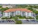 Beautiful multi-story condo building with a terracotta roof, surrounded by lush landscaping at 4001 Breakview Dr # D409, Orlando, FL 32819