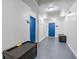 Hallway featuring blue doors and storage benches at 4001 Breakview Dr # D409, Orlando, FL 32819