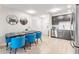 Stylish kitchen and dining area features stainless steel appliances and modern blue chairs at 4001 Breakview Dr # D409, Orlando, FL 32819