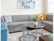 Cozy living room with a gray sectional sofa and decorative pillows at 4001 Breakview Dr # D409, Orlando, FL 32819