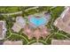 Aerial view of a luxurious community pool area with multiple pools and ample seating for relaxation at 4001 Breakview Dr # D409, Orlando, FL 32819