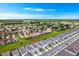 Wide aerial shot of a well-developed neighborhood with uniform houses and scenic green surroundings at 4021 Lana Ave, Davenport, FL 33897