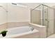 Luxurious bathroom with a soaking tub and glass-enclosed shower, perfect for relaxation and spa-like experiences at 4021 Lana Ave, Davenport, FL 33897