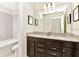 Modern bathroom boasts double sinks, dark wood cabinets, and granite countertops, with a separate toilet and tub at 4021 Lana Ave, Davenport, FL 33897