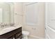 Bathroom features a granite countertop vanity and white toilet under a window at 4021 Lana Ave, Davenport, FL 33897