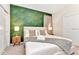 Comfortable bedroom with decorative wallpaper, a plush bed, and stylish nightstands at 4021 Lana Ave, Davenport, FL 33897