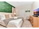 Well-lit bedroom with a luxurious bed, modern dresser, and decorative accents at 4021 Lana Ave, Davenport, FL 33897