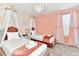 Charming bedroom with two twin beds and pink accents at 4021 Lana Ave, Davenport, FL 33897