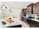 Modern kitchen with stainless steel appliances, dark cabinetry, and granite countertops, perfect for cooking at 4021 Lana Ave, Davenport, FL 33897
