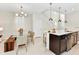Open-concept kitchen and dining area with stainless steel appliances and modern pendant lighting at 4021 Lana Ave, Davenport, FL 33897