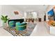 Spacious open-concept living room with a modern sofa, chairs, striped rug, and view to kitchen at 4021 Lana Ave, Davenport, FL 33897