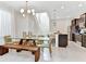 Open-concept kitchen and dining area with stainless steel appliances and wooden dining set at 4021 Lana Ave, Davenport, FL 33897