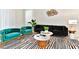 Bright living room featuring modern velvet furniture, zebra-striped rug, and contemporary décor at 4021 Lana Ave, Davenport, FL 33897