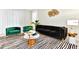Modern living room setup with dark furniture, zebra striped rug, and contemporary decor at 4021 Lana Ave, Davenport, FL 33897