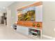 Modern Gathering room with large TV and display over light cabinets, with view to the kitchen at 4021 Lana Ave, Davenport, FL 33897