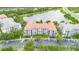 Aerial view of resort condos with a red tile roof, surrounded by trees and overlooking a large lake at 4114 Breakview Dr # 110, Orlando, FL 32819