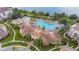 Aerial view of a community pool area featuring lush landscaping, lounge chairs, and resort-style amenities at 4114 Breakview Dr # 110, Orlando, FL 32819