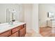 Large vanity in bathroom featuring tile flooring, a large mirror, and a doorway to bedroom at 4114 Breakview Dr # 110, Orlando, FL 32819