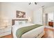 Bright bedroom features queen bed, wood floors, and ensuite bathroom at 4114 Breakview Dr # 110, Orlando, FL 32819