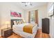 Cozy bedroom features queen bed, wood floors, and private outdoor access at 4114 Breakview Dr # 110, Orlando, FL 32819