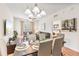 Bright dining area with modern table setting and an adjacent living room and bedroom space at 4114 Breakview Dr # 110, Orlando, FL 32819